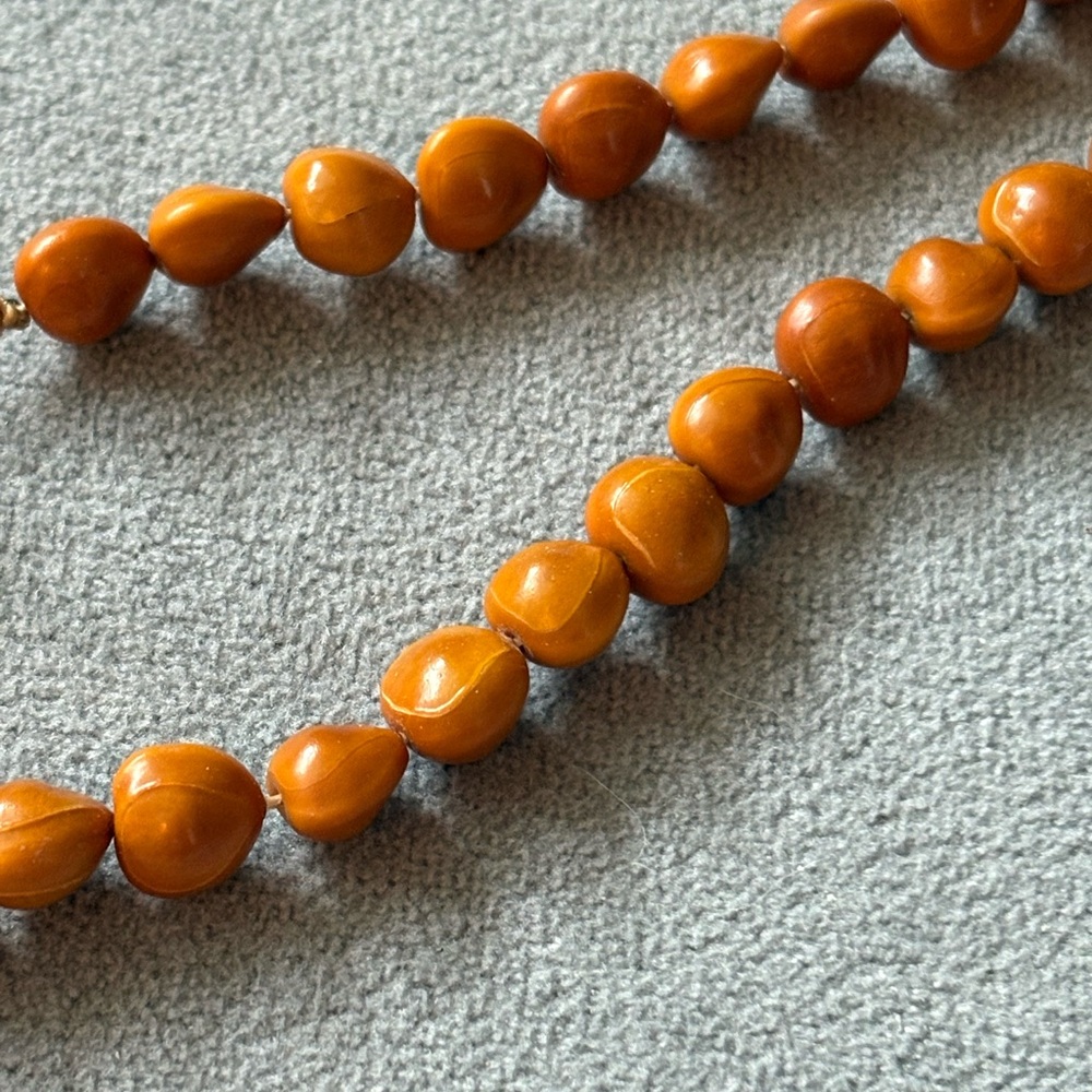 Mustard açaí bead necklace handmade by Brazilian indigenous women